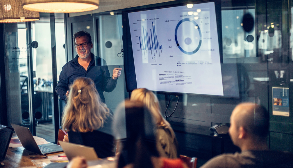 business meeting and a man showing a dashboard